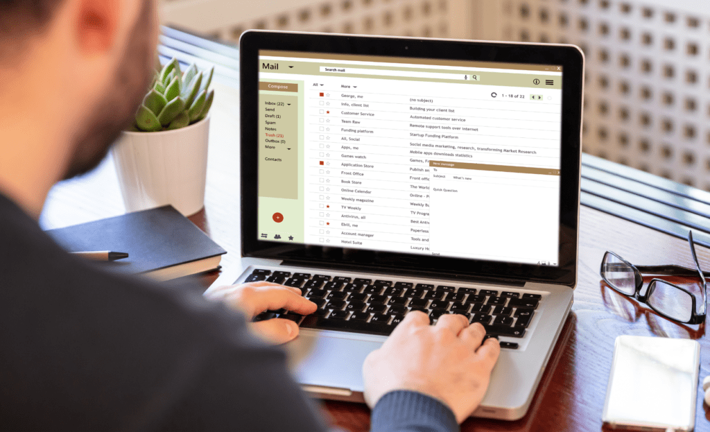 Business owner sending an email on his computer