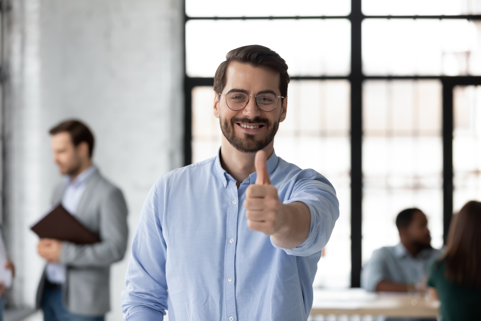 Small business owner thumbs up looking at the camera and smiling